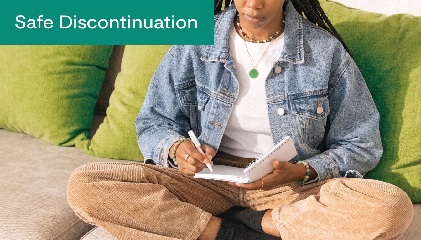 A person sitting on a sofa writing in a notebook, labeled with the words Safe Discontinuation.
