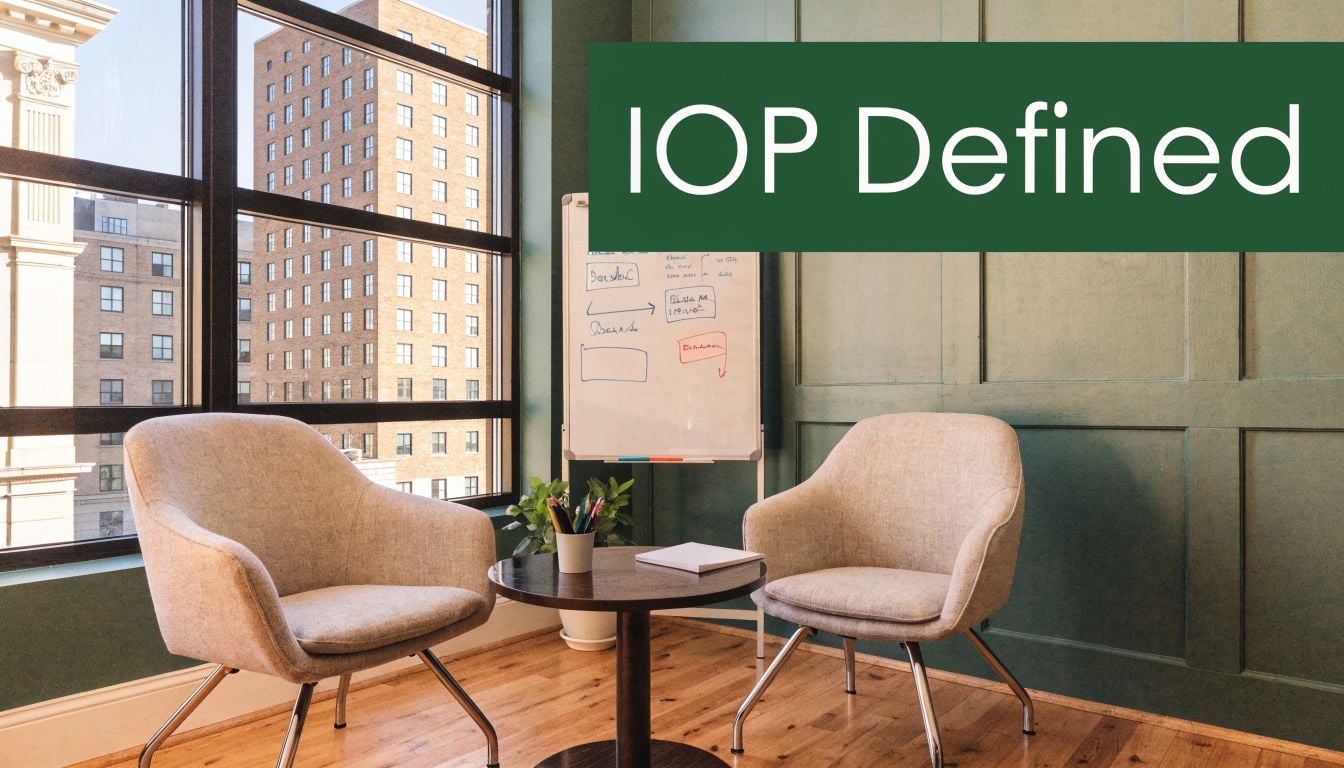 A modern office space featuring two comfortable chairs, a small wooden table, and a whiteboard with notes.