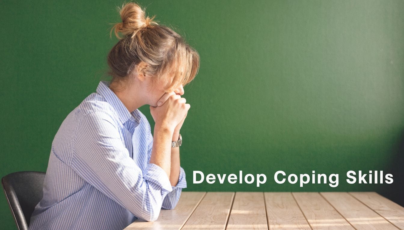A woman sits at a table appearing stressed or pensive against a solid green background.