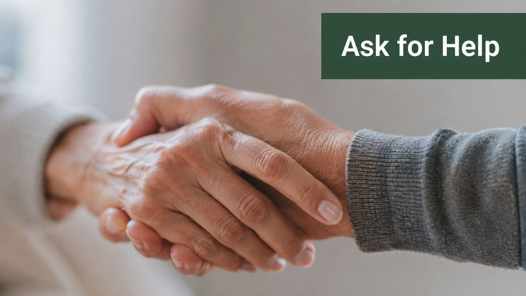 Two people shaking hands, symbolizing support, connection, and the act of asking for help.